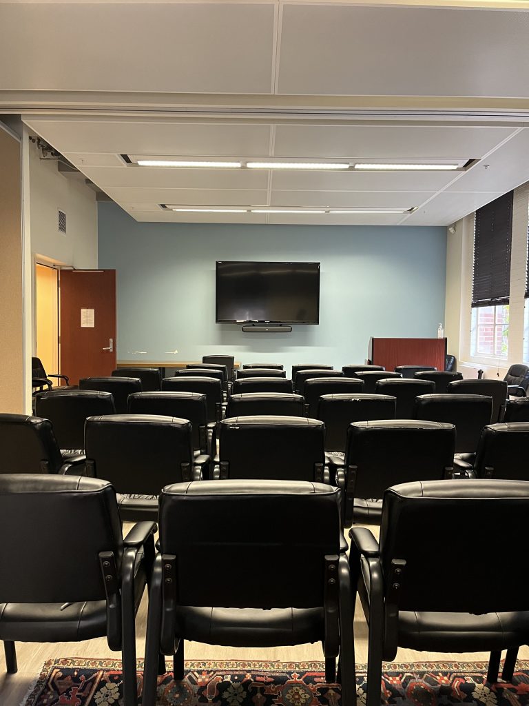 Image of a room with chairs and a media display